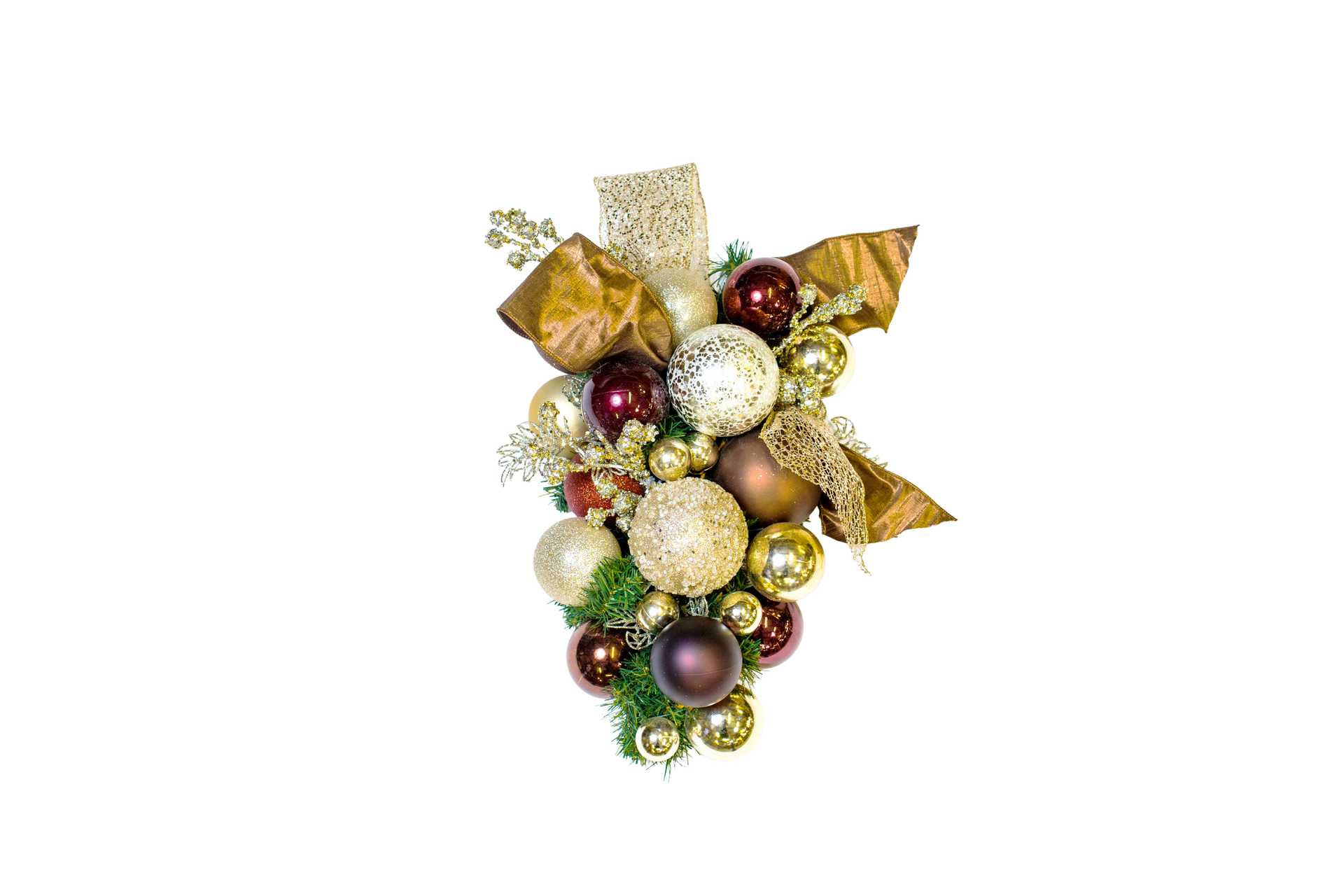 Christmas ornament cluster with gold, brown, and red baubles, greenery, and ribbon.