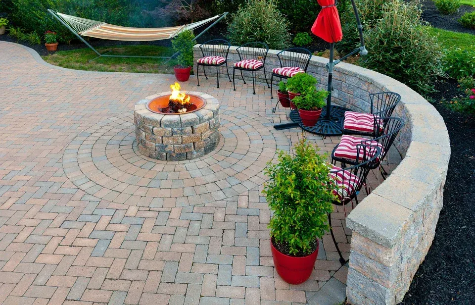 There is a fire pit in the middle of the patio.