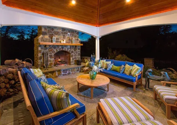 There is a fireplace in the middle of the patio.