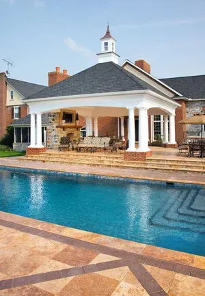A large house with a large swimming pool in front of it