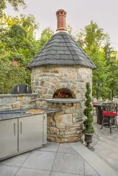 A brick wall with a lamp on top of it next to a garage door.
