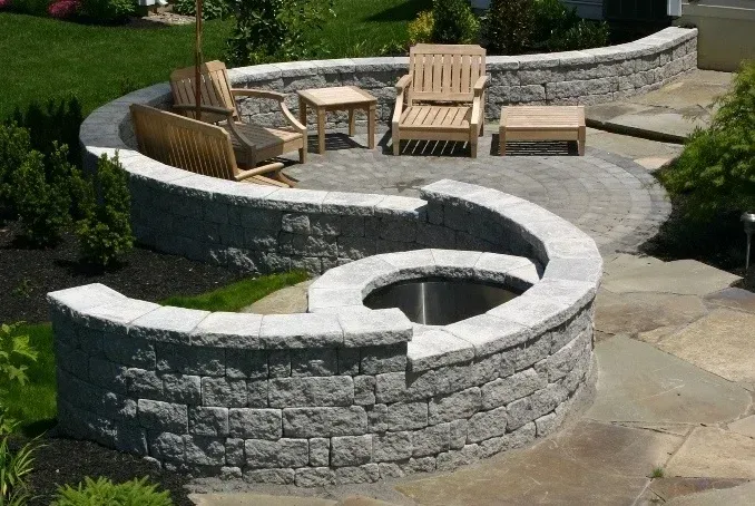 There is a fire pit in the middle of the patio.