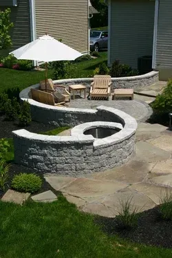 There is a fire pit in the middle of the backyard.