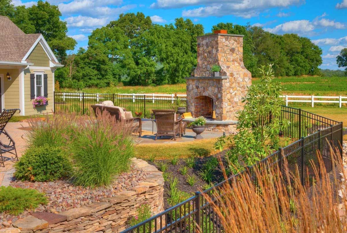 There is a fireplace in the backyard of a house.