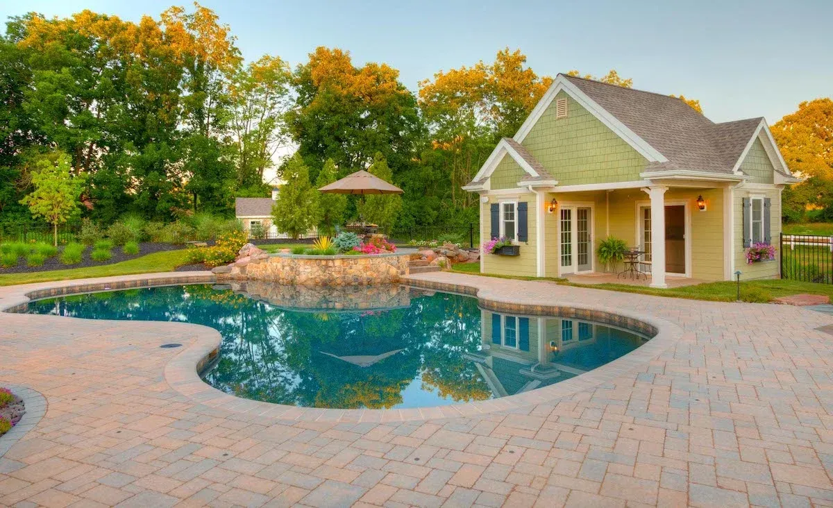 A house with a swimming pool in front of it