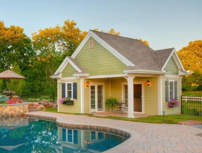 A small house with a swimming pool in front of it