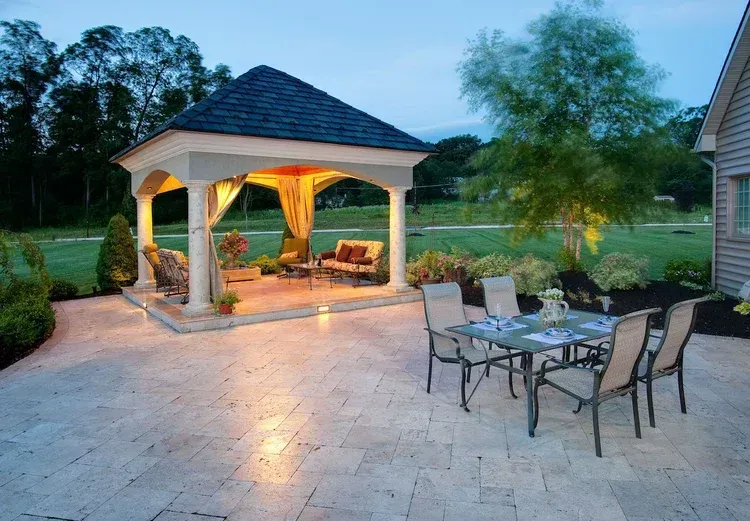 A gazebo with a table and chairs underneath it