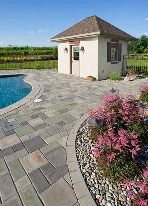 A small white house sits next to a swimming pool