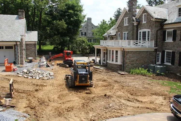 A large house with a lot of dirt in front of it