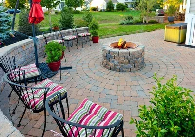 There is a fire pit in the middle of the patio.