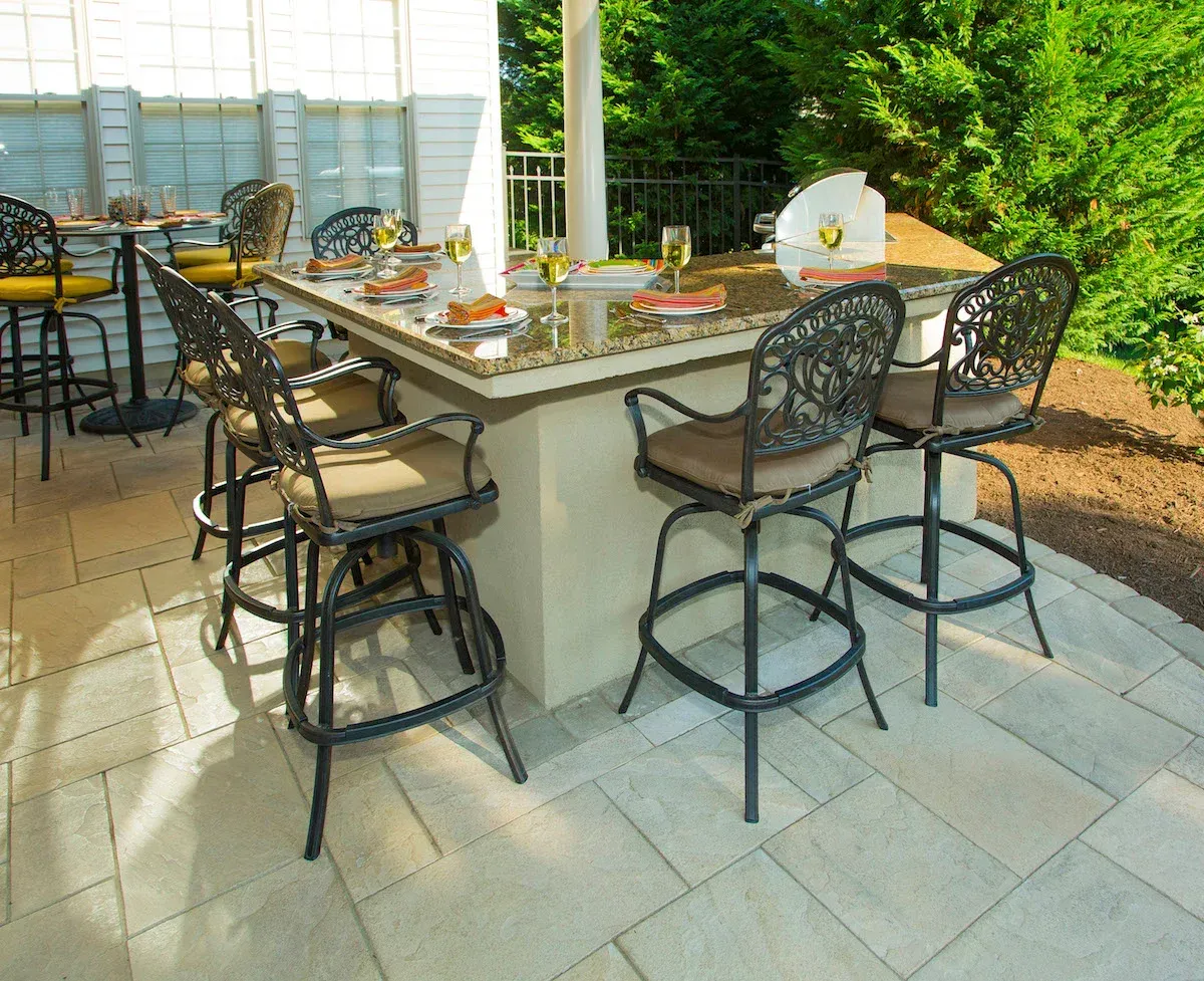 A patio with a table and chairs set up for a party