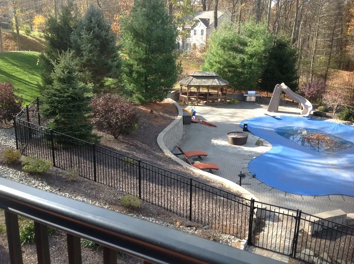 A view of a park from a balcony with a fence around it