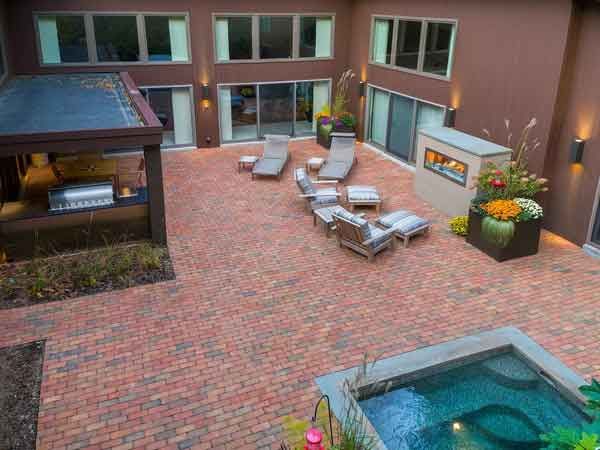 An aerial view of a patio with a pool and a fireplace.