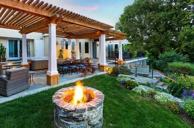 There is a fire pit in the middle of the backyard.