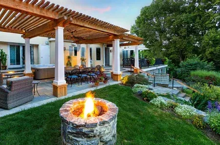 There is a fire pit in the middle of the backyard.