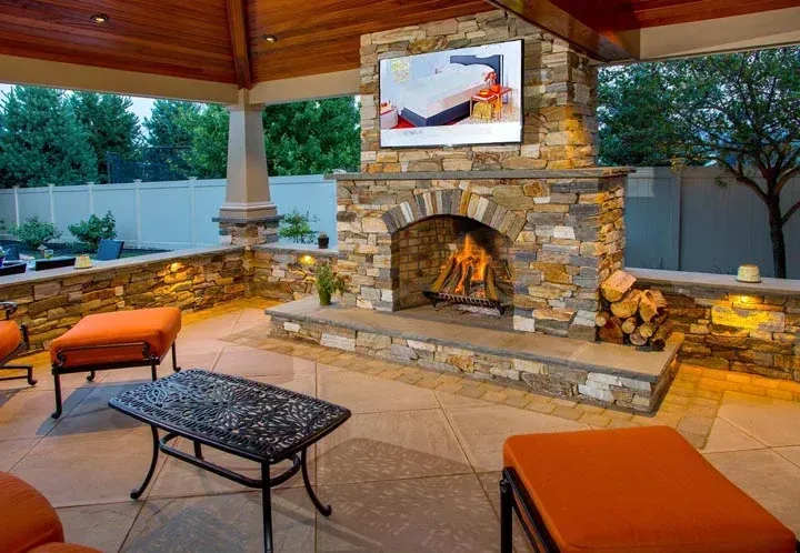 A stone fireplace with a flat screen tv above it