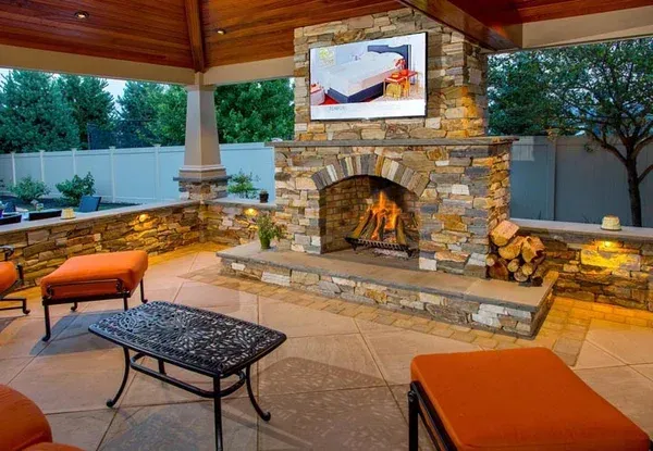 A brick wall with a lamp on top of it next to a garage door.