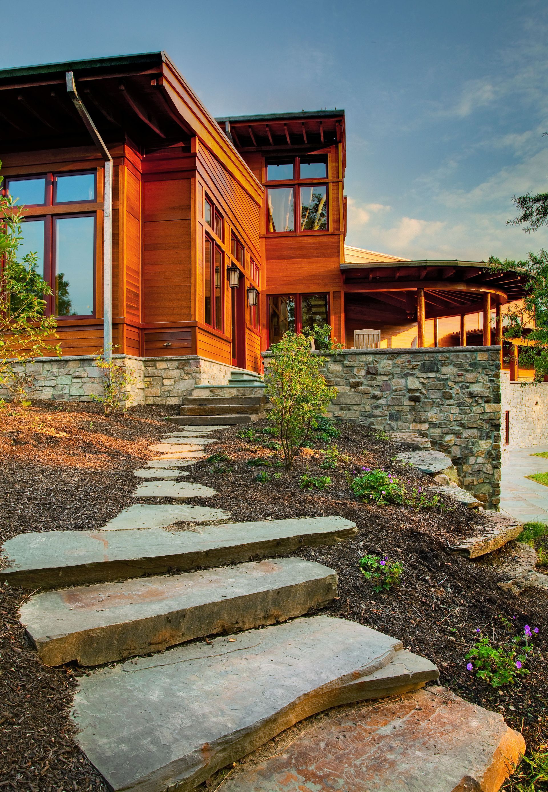 A wooden house with stone steps leading up to it