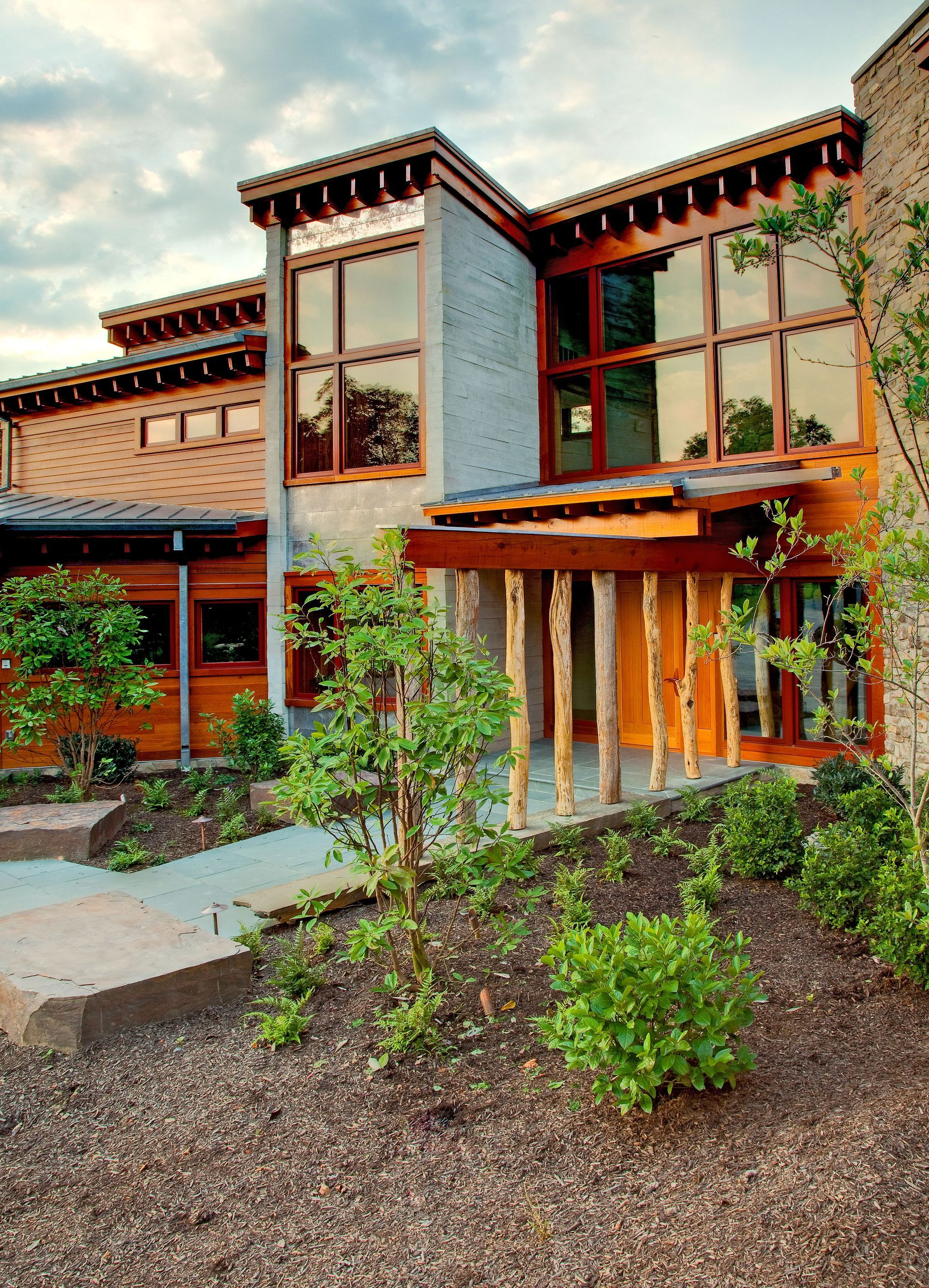 A large house with a lot of windows and trees in front of it