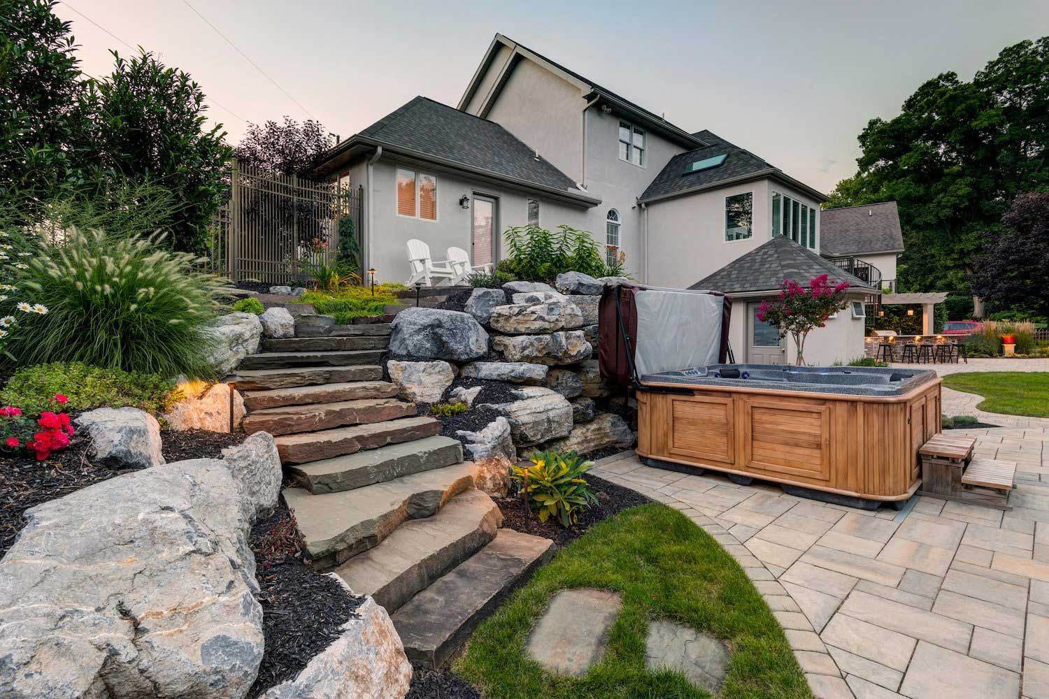 There is a hot tub in the backyard of a house.