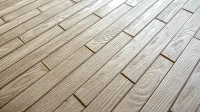 A close up of a wooden floor with a diagonal pattern.