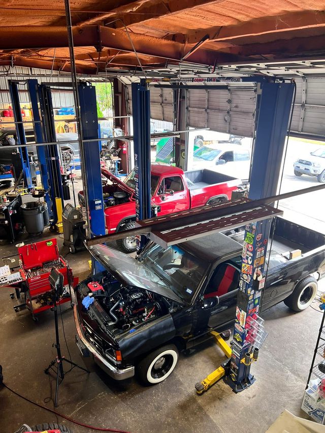 Multiple Vehicles on Hydraulic Lifts Inside Auto Repair Facility | Black’s Automotive & Diesel