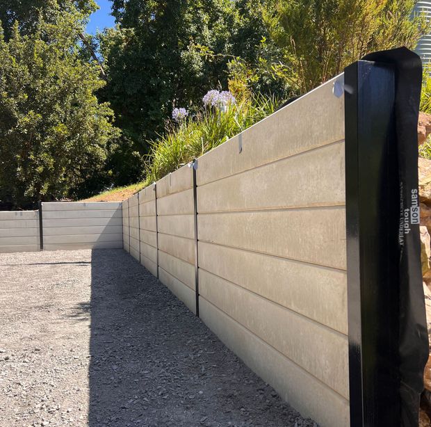 a set of stairs leading up to a retaining wall .