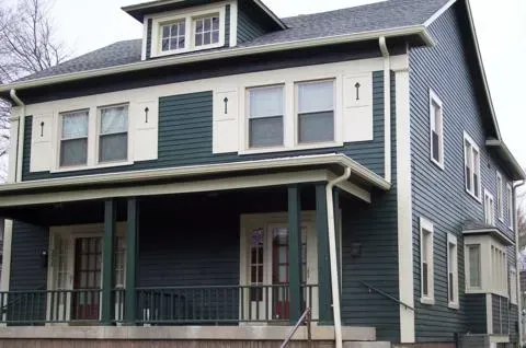 Blue two-story house with white trim and a covered front porch