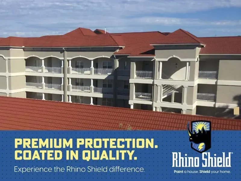 Apartment building with red roof behind Rhino Shield ad reading “Premium Protection. Coated in Quality.”