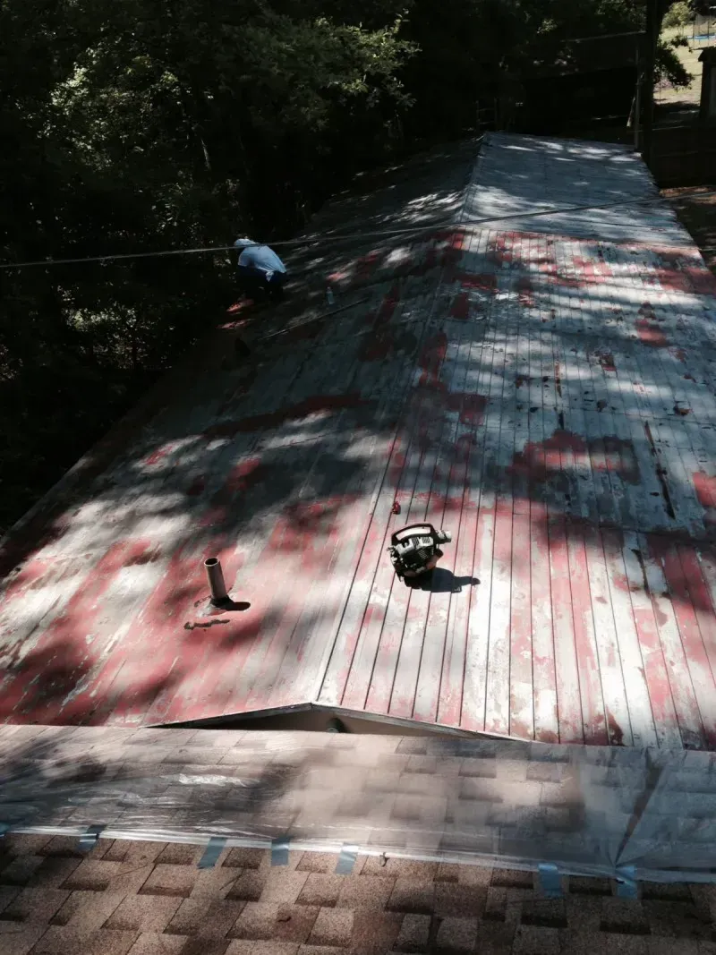 Rooftop covered with red and white stripes, with a few small objects near the top and left side.