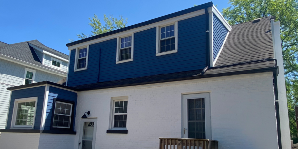 Blue-and-white house exterior with dormer windows and a small front porch