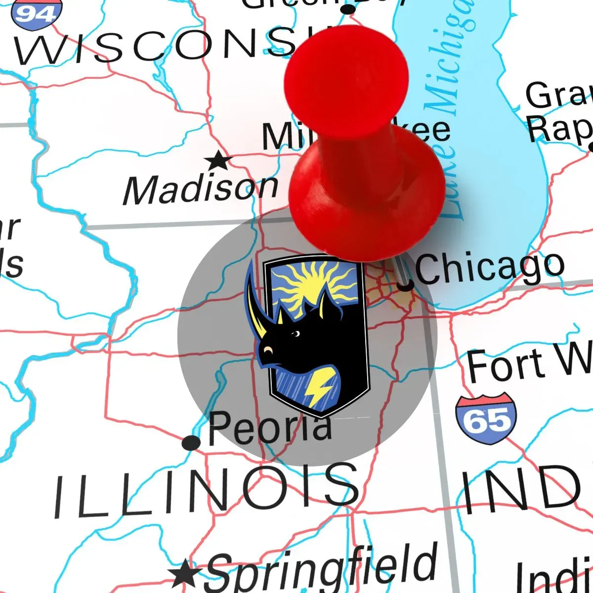 Red pushpin on a Wisconsin-Illinois map near Chicago and Peoria