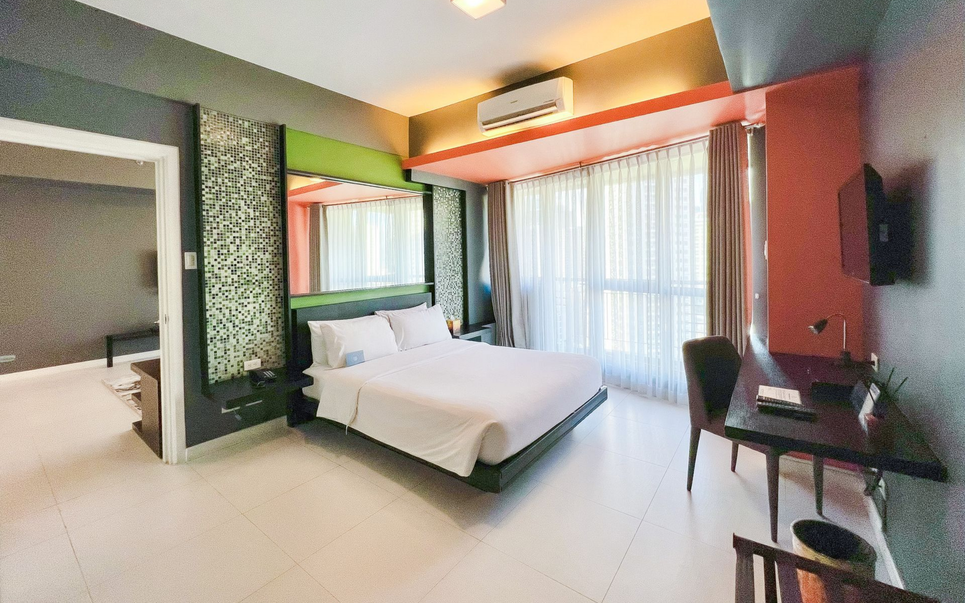 Elegant living room with vibrant red accents and comfortable seating, perfect for meetings or relaxing near Greenbelt