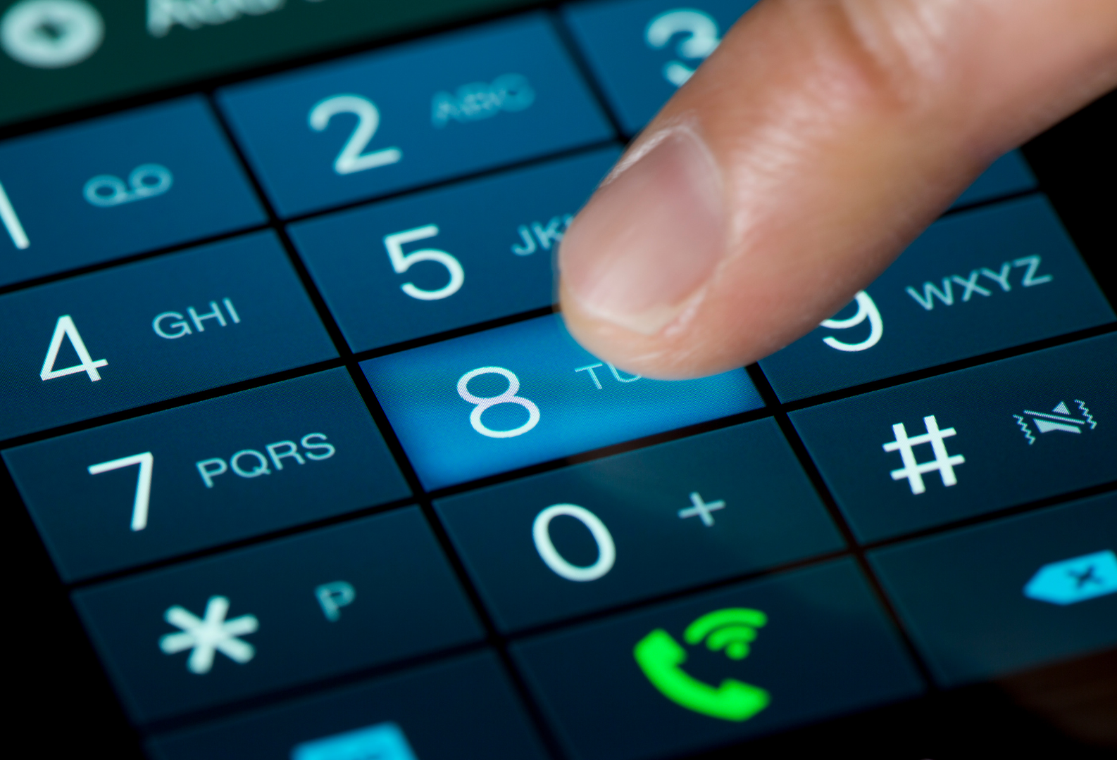 Finger pressing the number 8 on a smartphone's dial pad.
