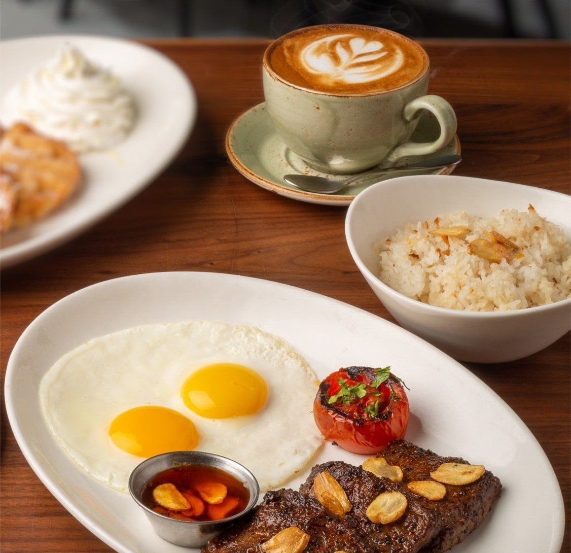 Filipino breakfast with steak, fried eggs, garlic rice, and latte at KL Ser