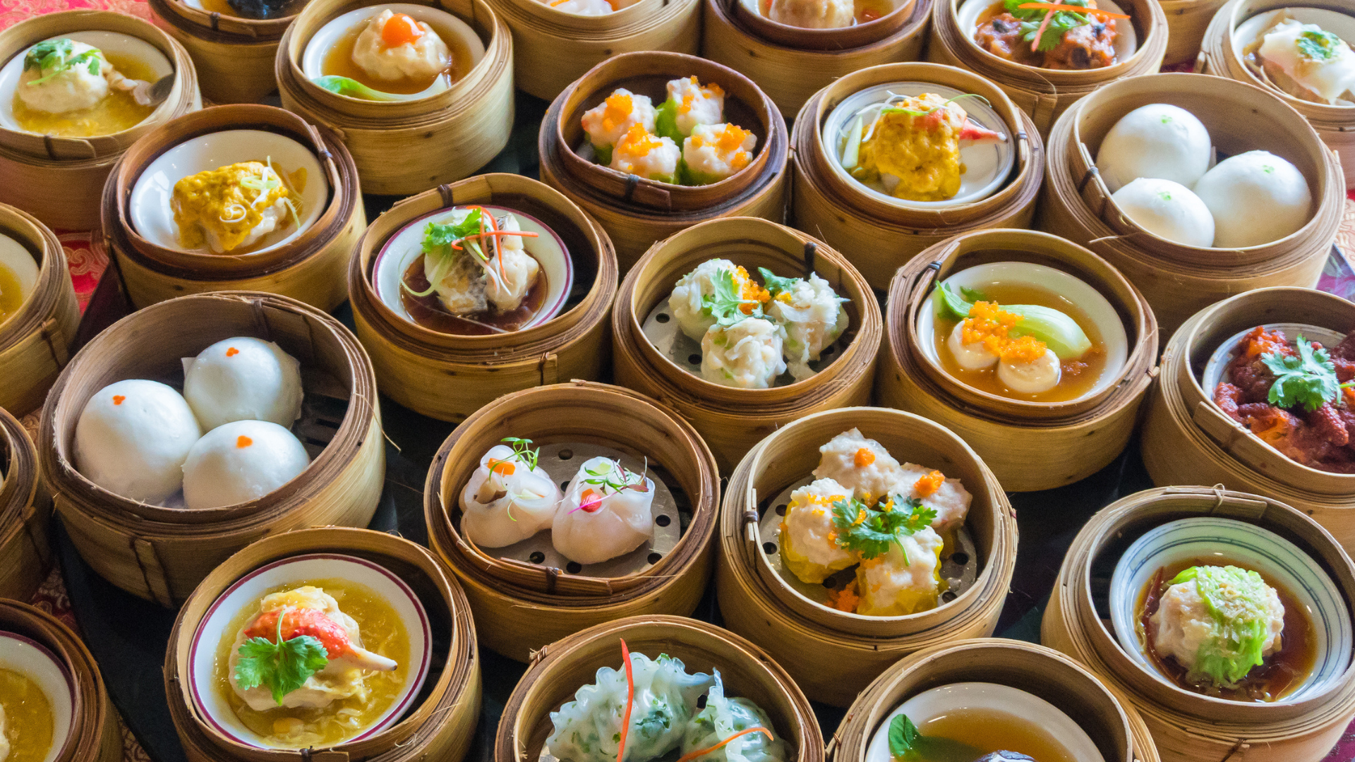 Dim sum in bamboo steamers, various fillings visible.