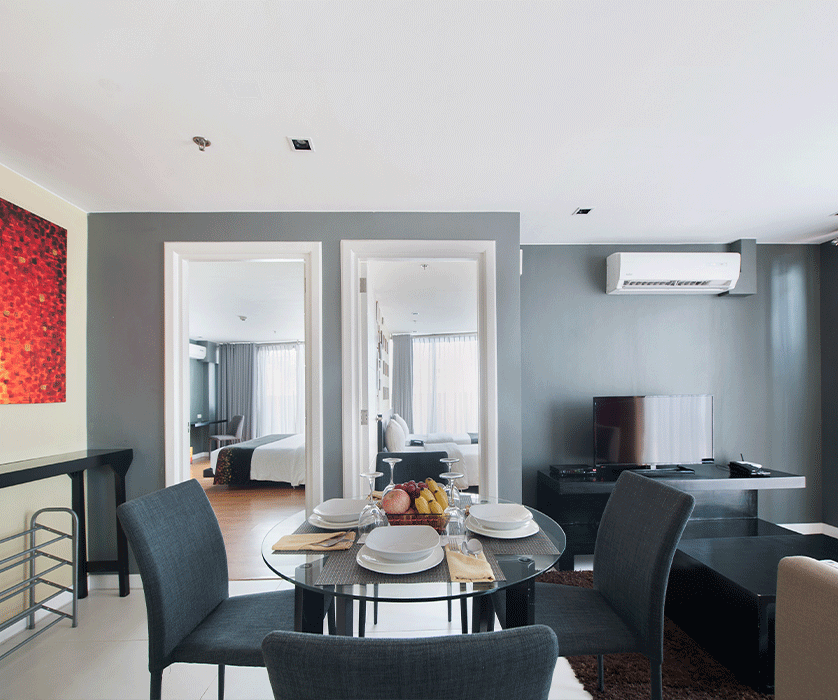 Modern serviced apartment dining area with gray walls in Makati
