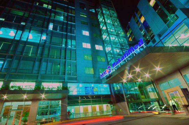 Modern hotel facade illuminated at night, a prime location for hotels near Greenbelt Makati