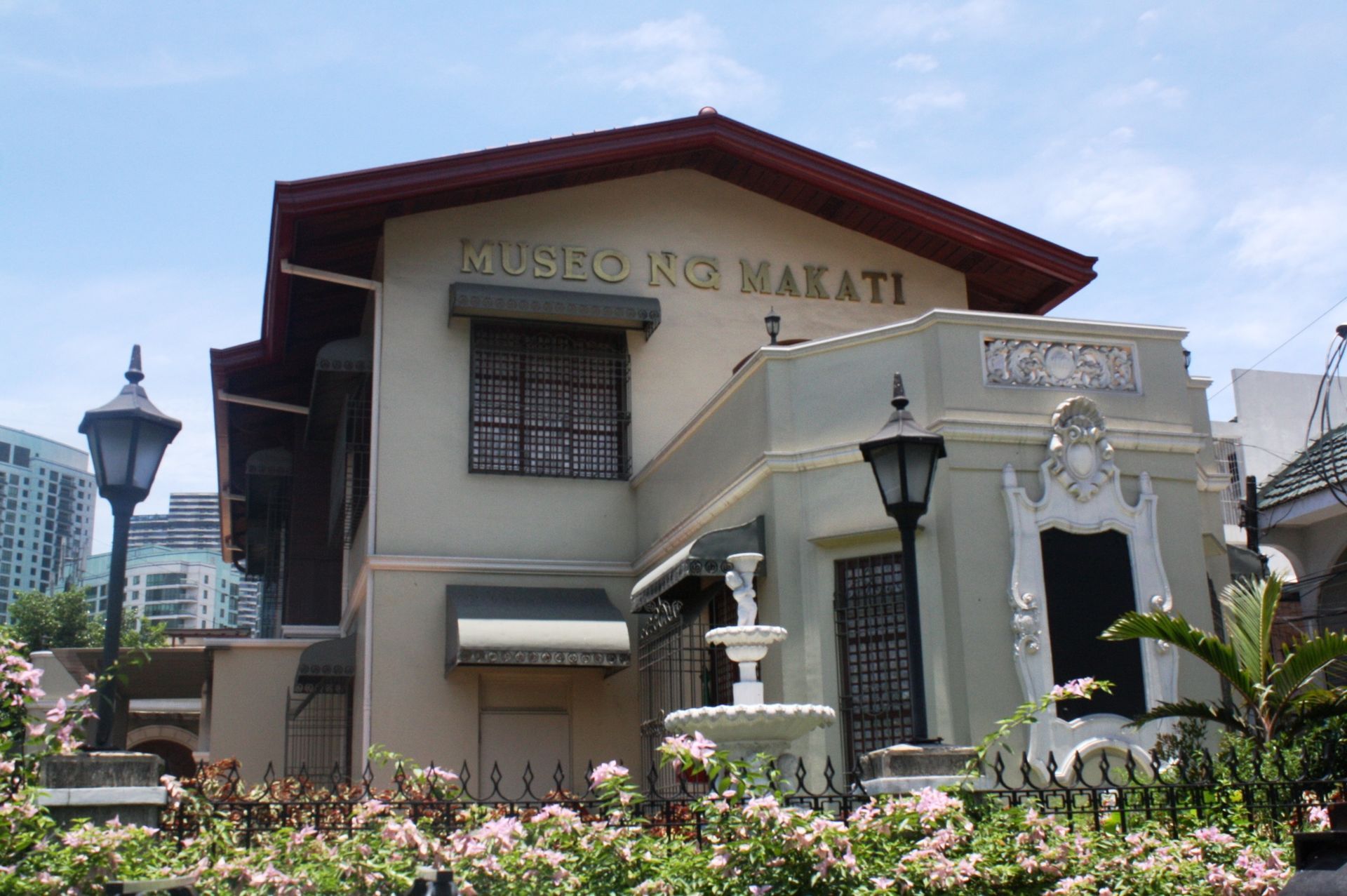 Museo ng Makati historic building with fountain and pink flowers
