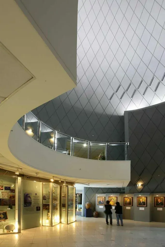 Modern museum atrium with portrait gallery and curved balcony in Makati