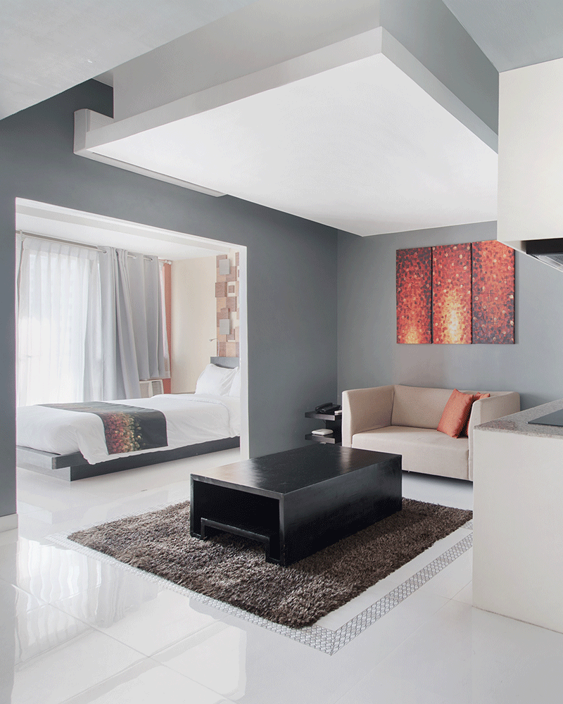 Two Bedroom Suite with spacious living area, modern furnishings and colorful art accent, ideal for family staycations.