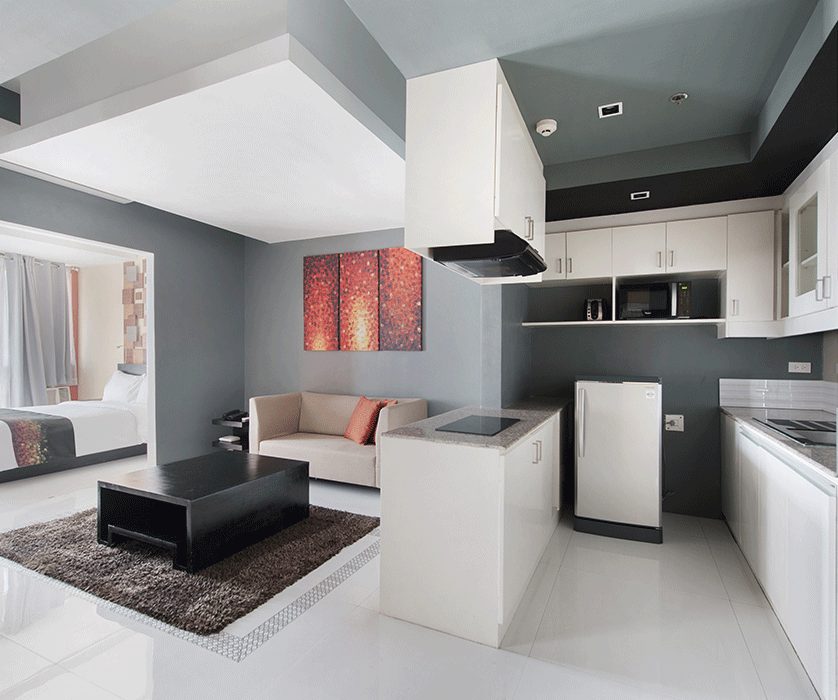 Modern studio suite with open kitchen and living area at KL Serviced Reside