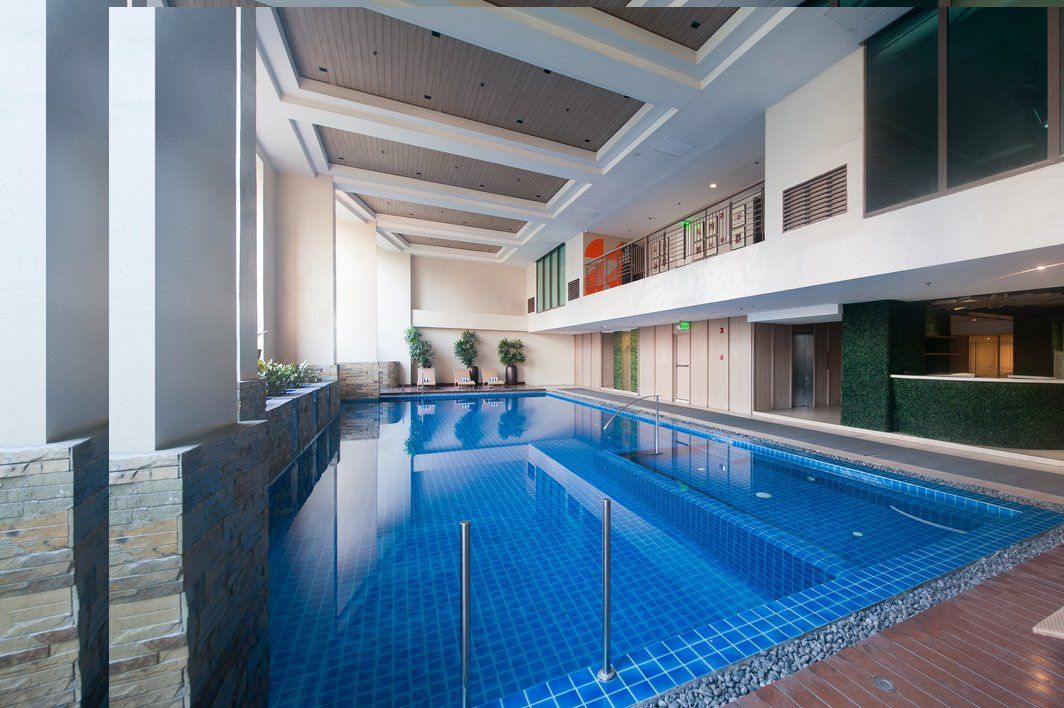 Indoor lap pool with blue mosaic tiles at KL Serviced Residences Makati