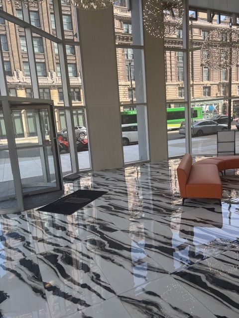 A large room with a marble floor and a couch