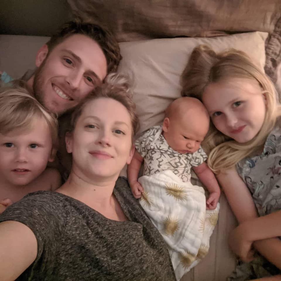 A wooden fence is sitting in the middle of a grassy field.