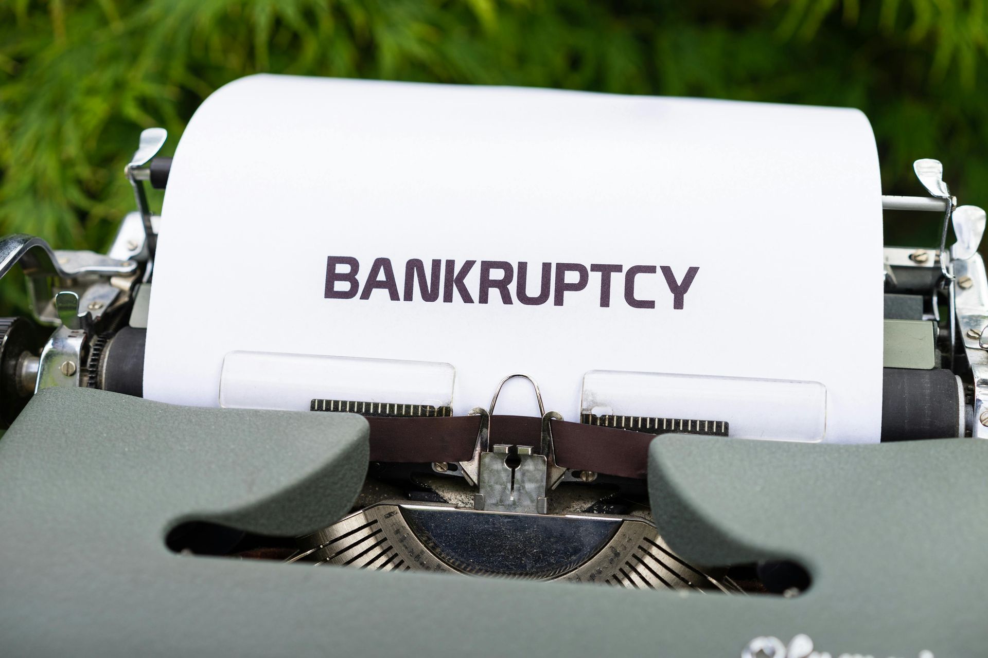 Typewriter with paper displaying the word 