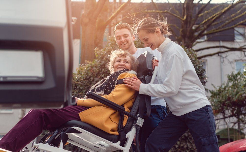 Volunteers Helping Elderly Woman Into Vehicle — Aged Care Services in Paget, QLD