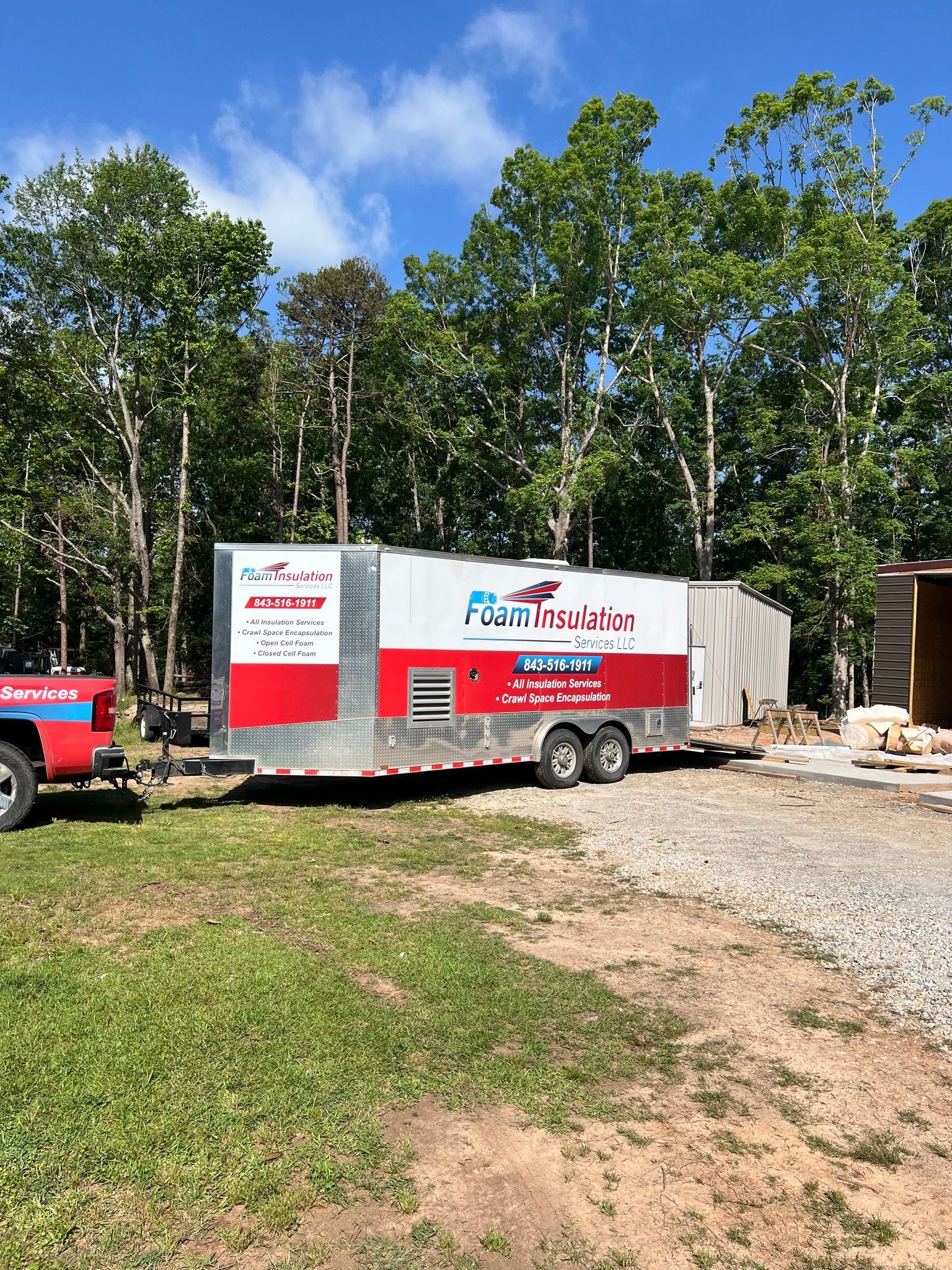 Mobile medical clinic trailer parked on gravel, with a truck attached.
