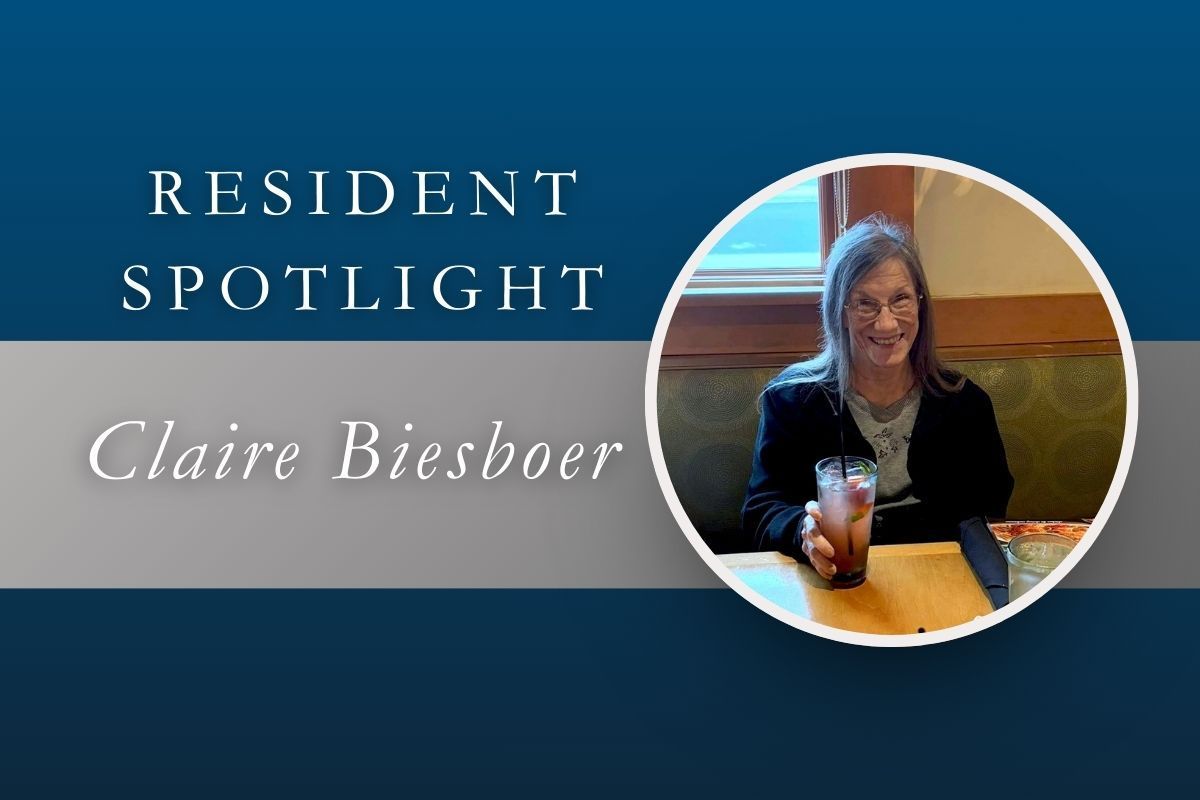 Resident Spotlight: Claire Biesboer, woman sitting at a table with a drink.