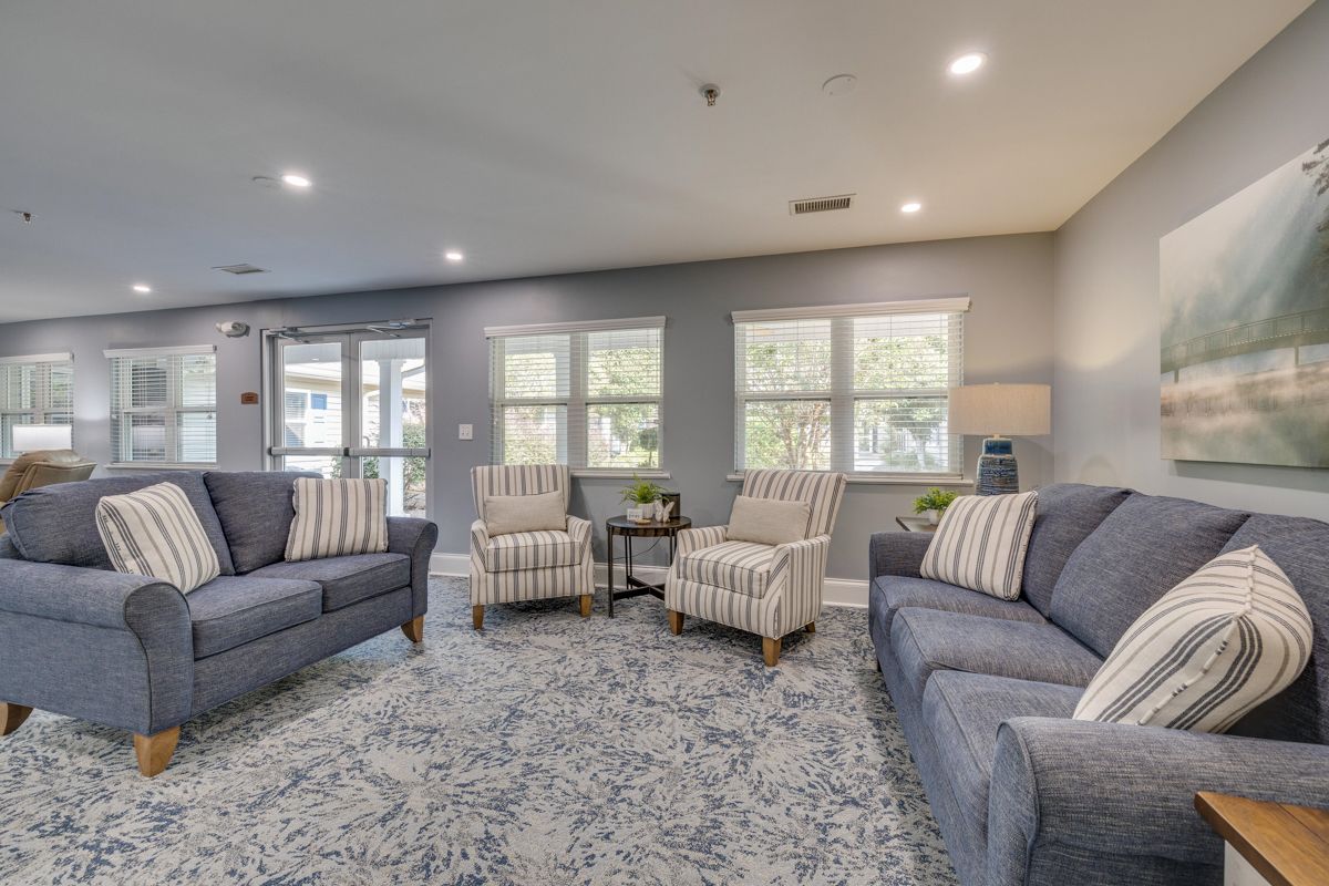 There are two couches and two chairs in the living room.